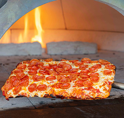 pepperoni pizza in front of oven